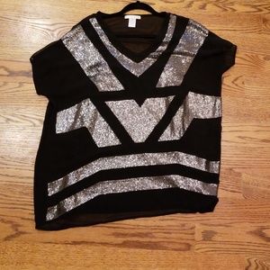 Black top with silver sequin pattern.